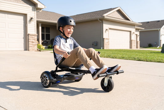 Child in a helmet driving a hoverboard and hoverkart seat bundle on a driveway