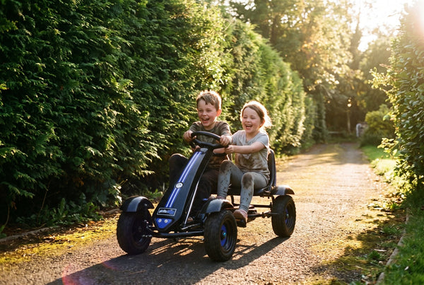 Two children racing a Gorilla Karts Bolt pedal go-kart down a garden path