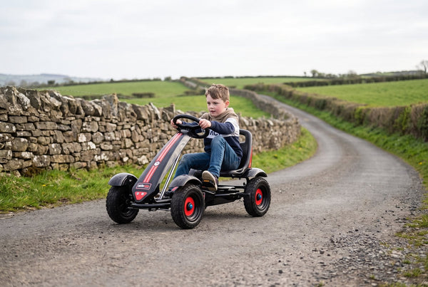 Boy pedalling a Gorilla Karts Inferno pedal go-kart along a Northern Ireland country lane
