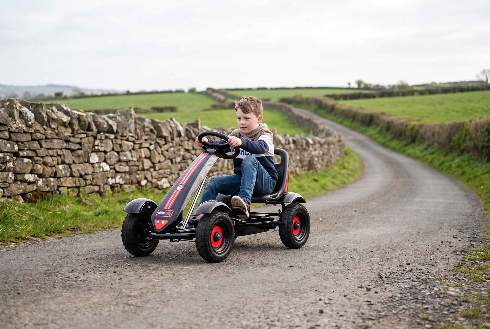 Boy pedalling a Gorilla Karts Inferno pedal go-kart along a Northern Ireland country lane