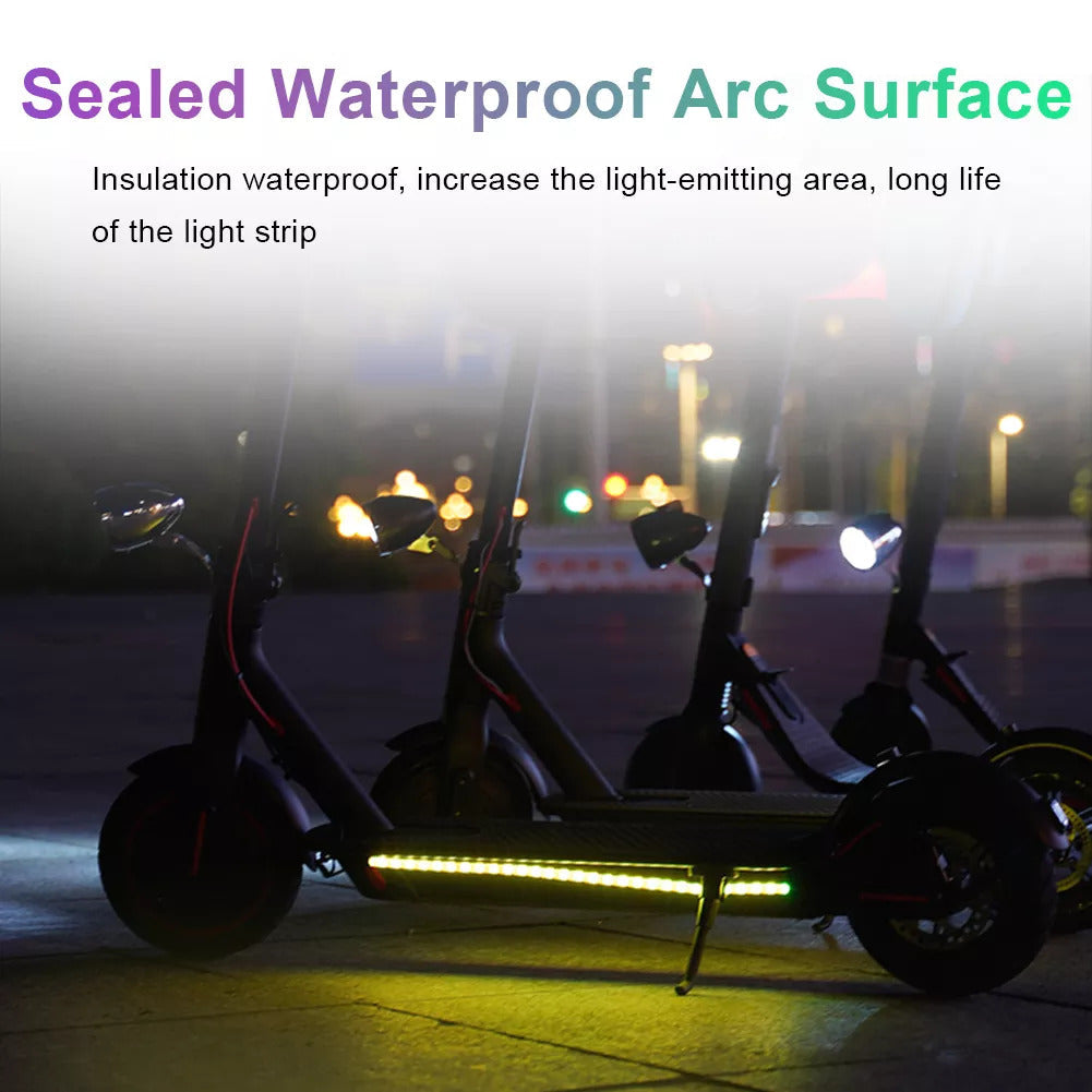 Scooters at night with the LED strips lit along the deck